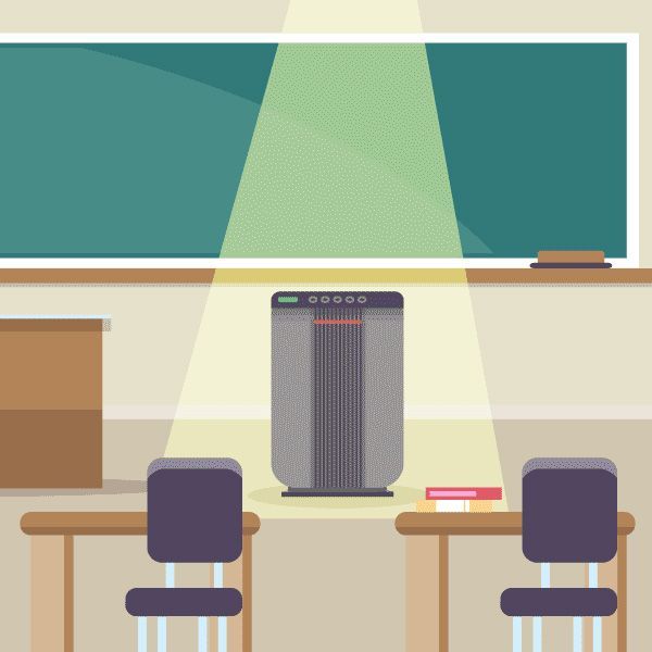 A classroom with a blackboard , desks , chairs and a computer.