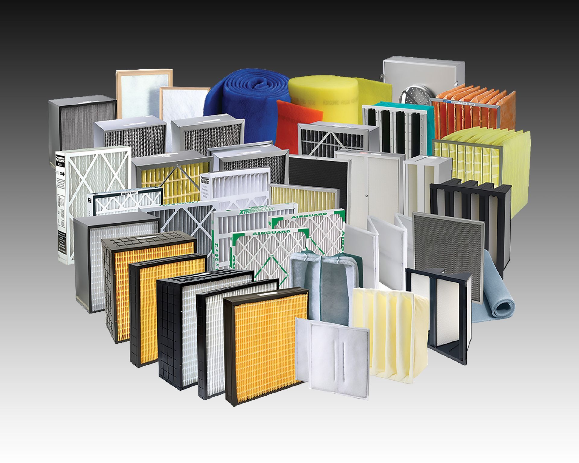 A bunch of different types of filters are stacked on top of each other on a table.