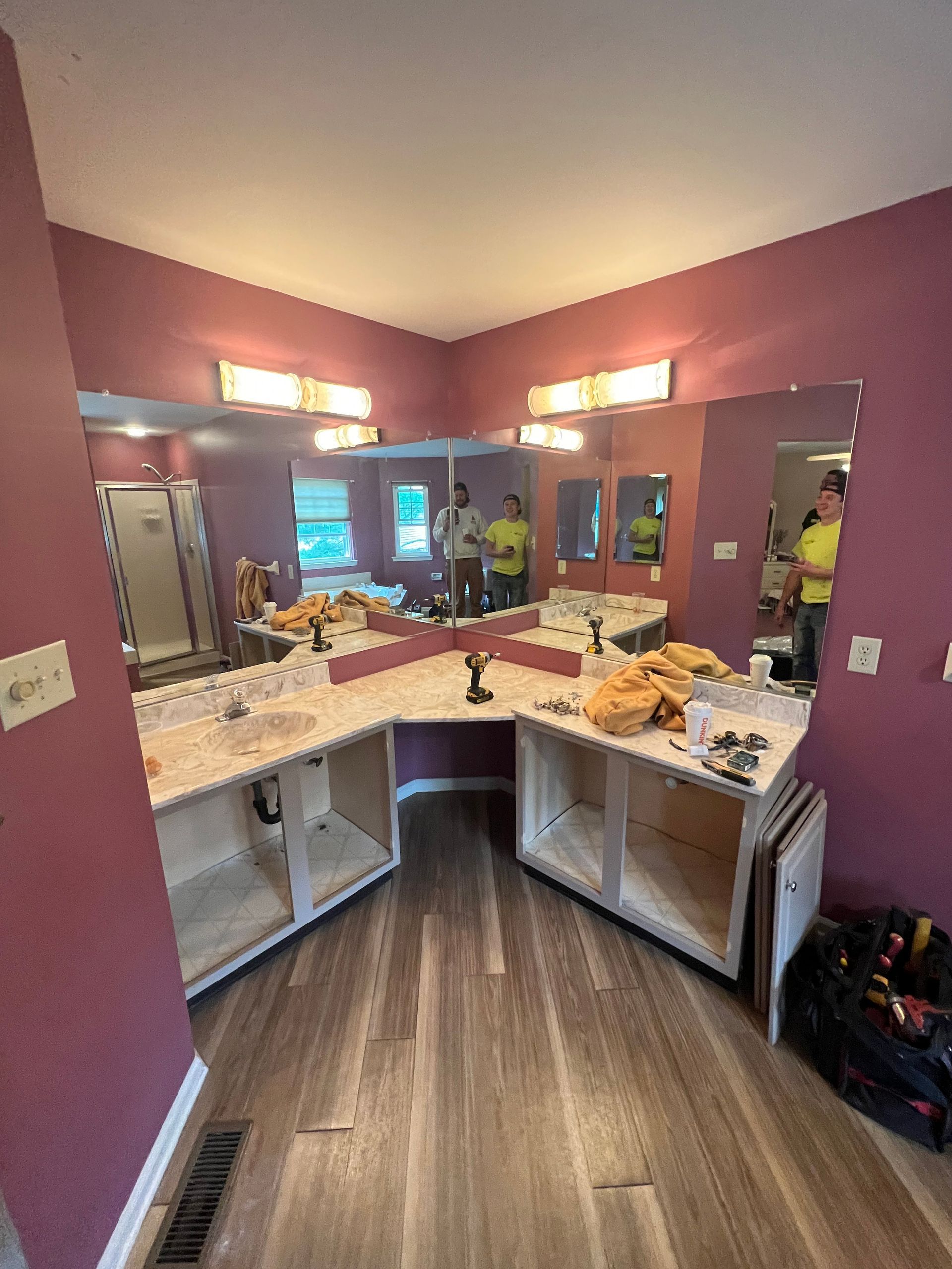 Bathroom with cabinets, mirrors, and vanity - before