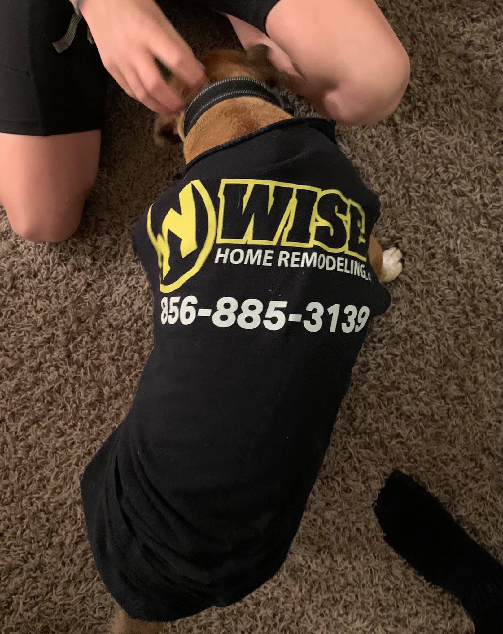 A dog wearing a shirt that says wise home remodeling