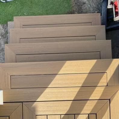A set of wooden stairs leading up to a deck.