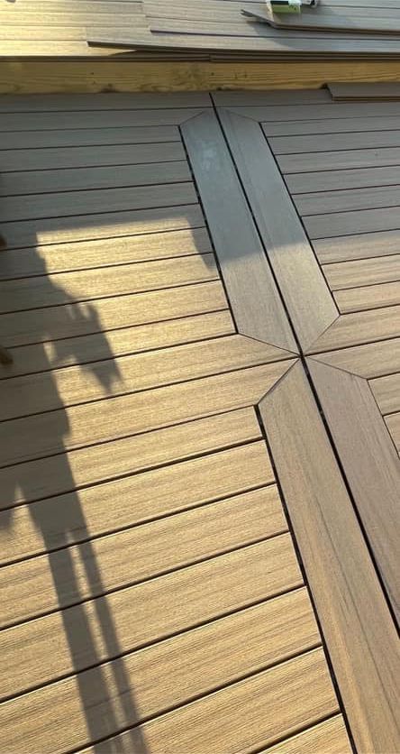 A wooden deck with a table and chairs on it.