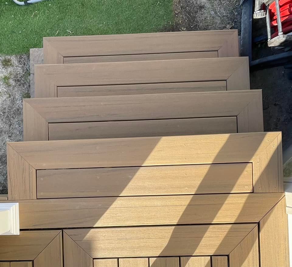 A set of wooden stairs with a shadow on the ground