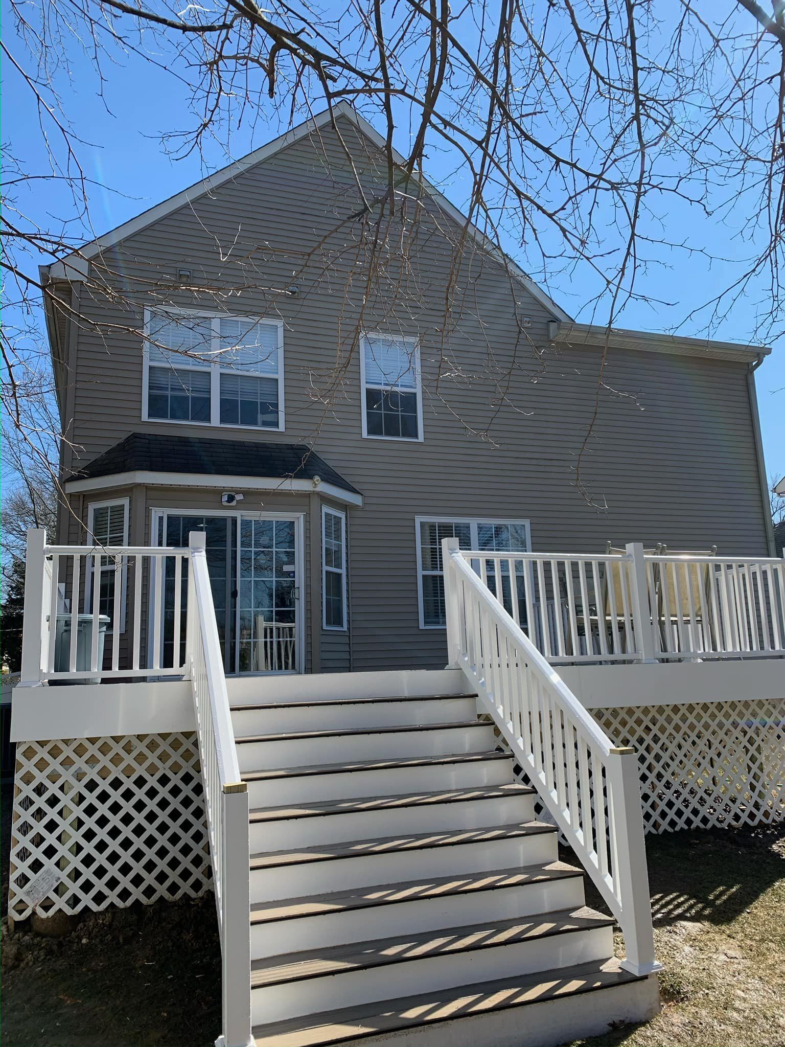 A house with a deck and stairs leading up to it