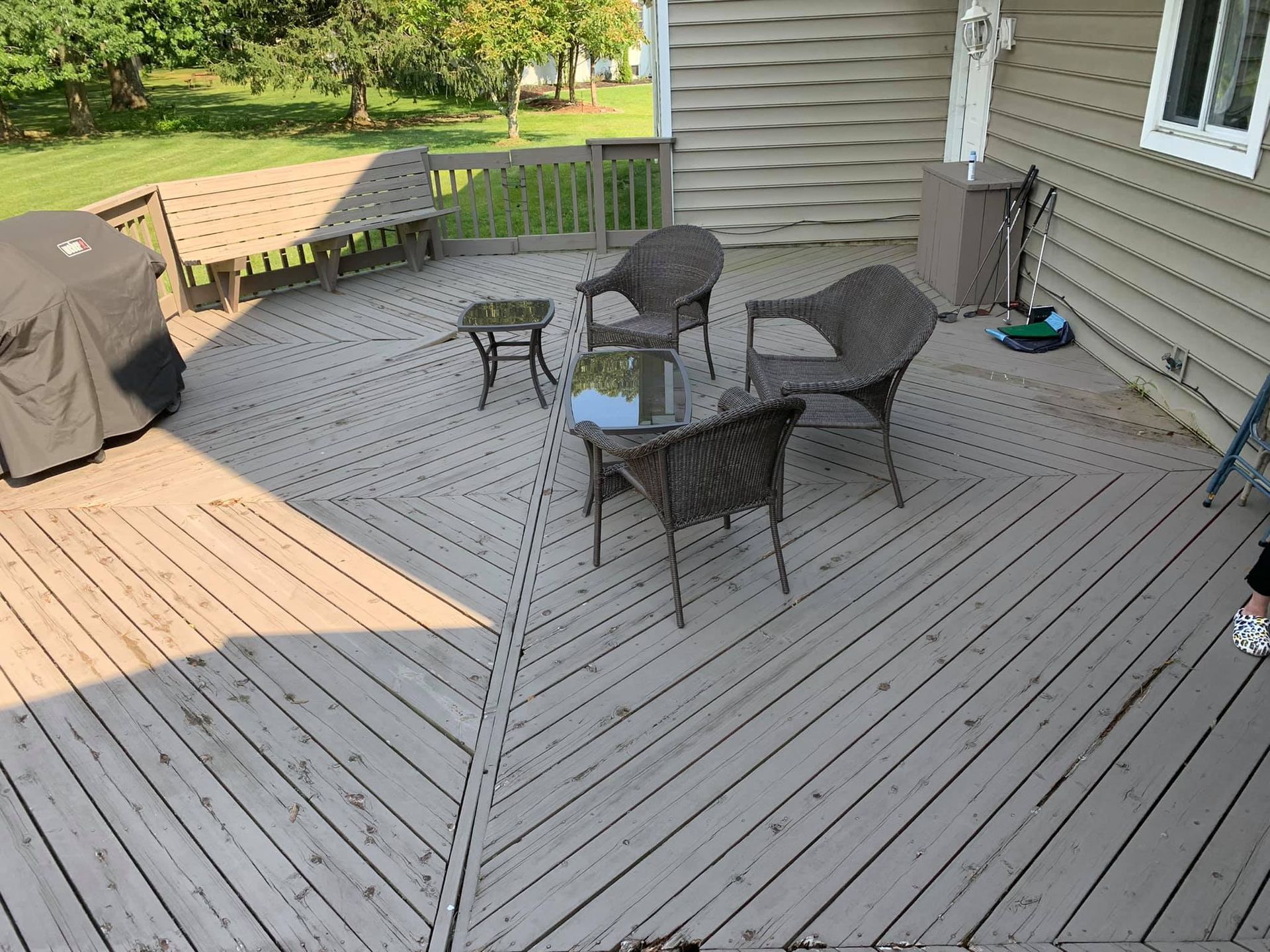 A wooden deck with chairs and a table on it