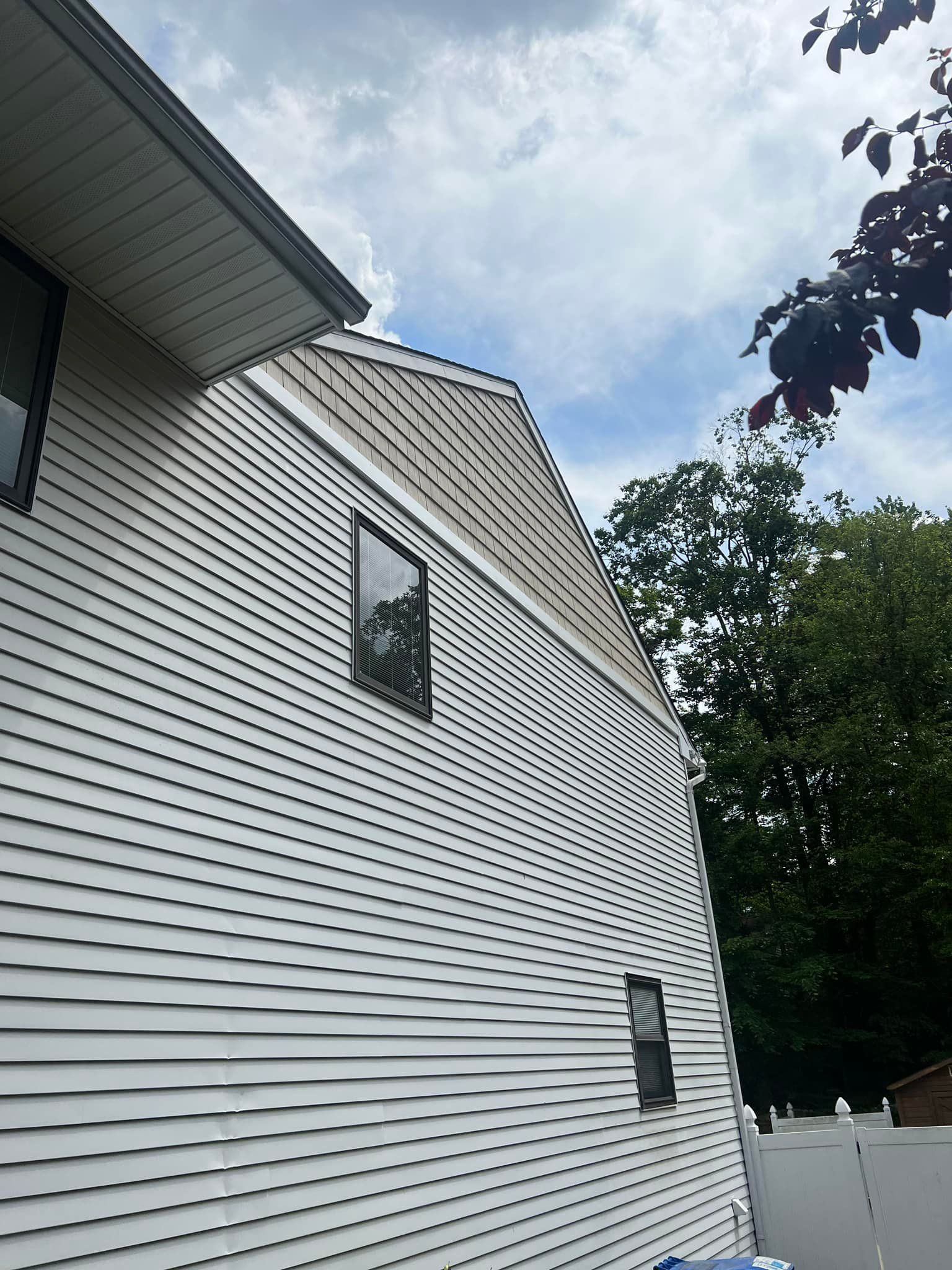 A white house with a window on the side of it.