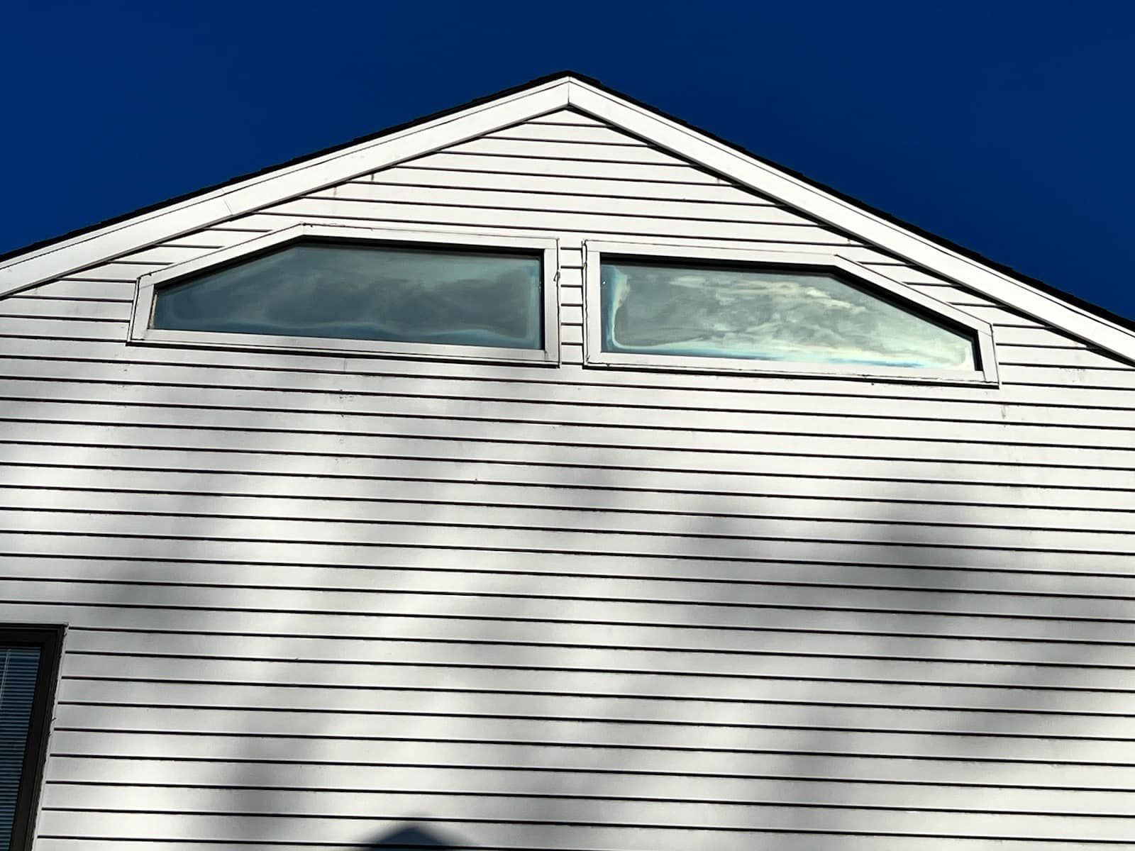 A white house with a blue sky in the background