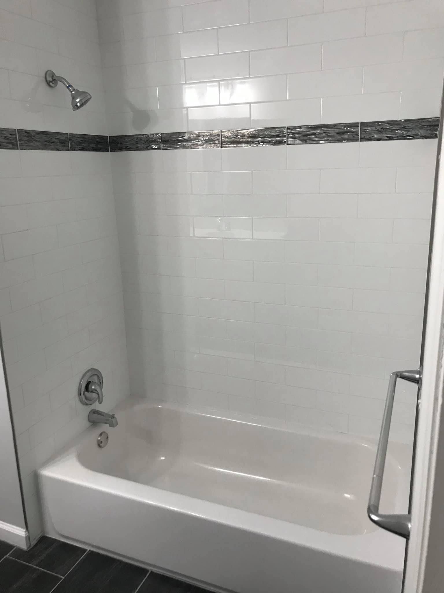 A bathroom with a bathtub and a shower.