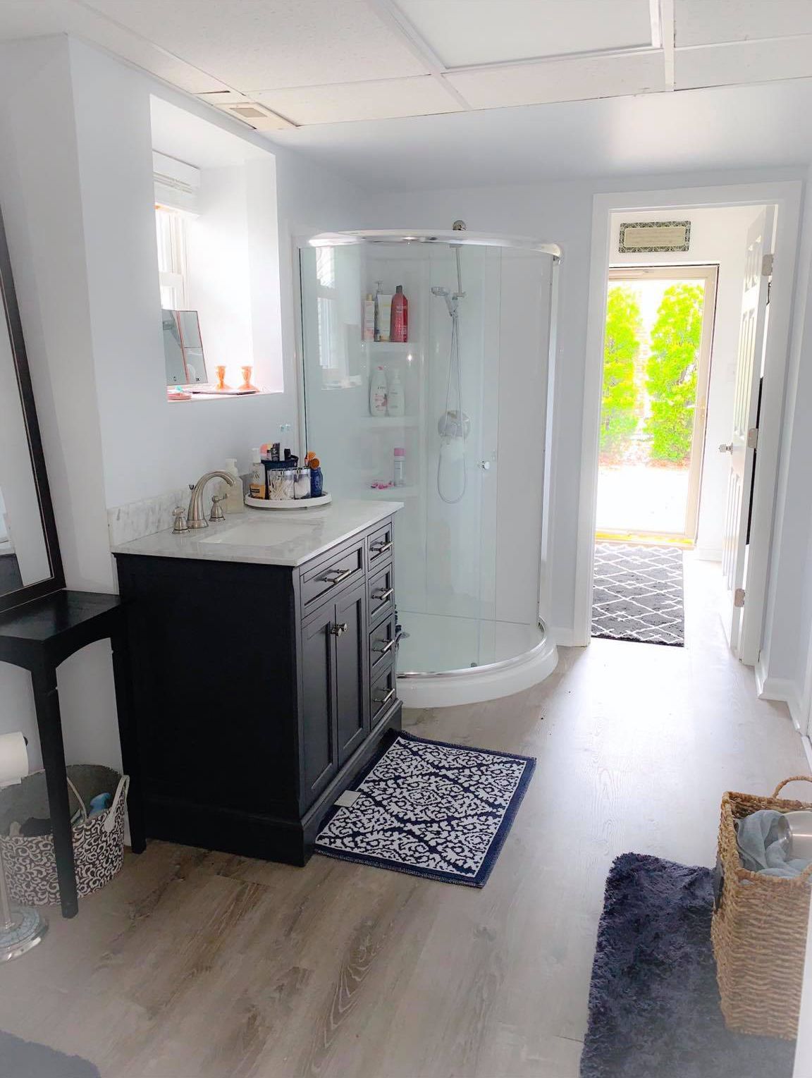 A bathroom with a sink and a walk in shower