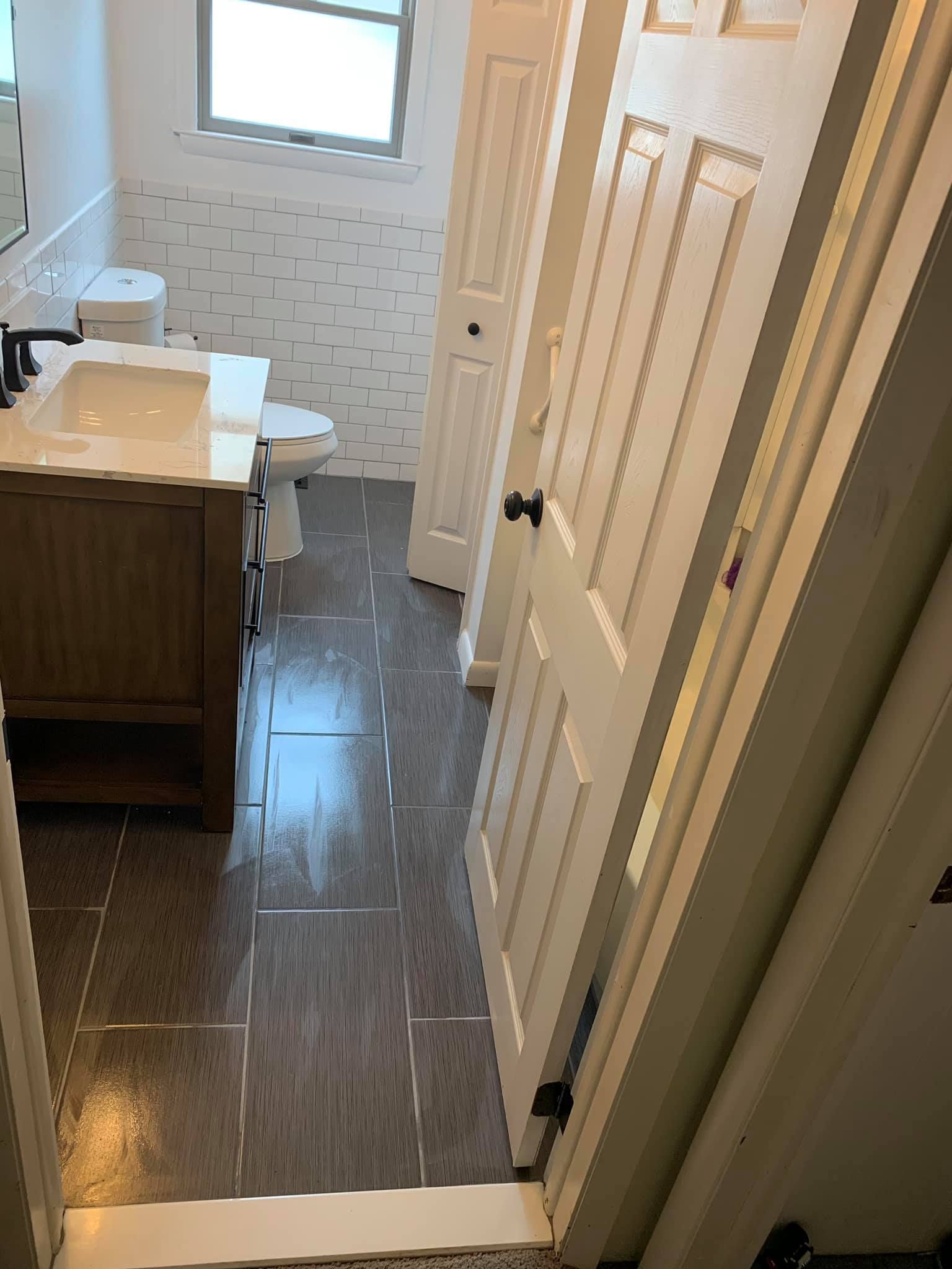 A bathroom with a sink , toilet , and mirror.