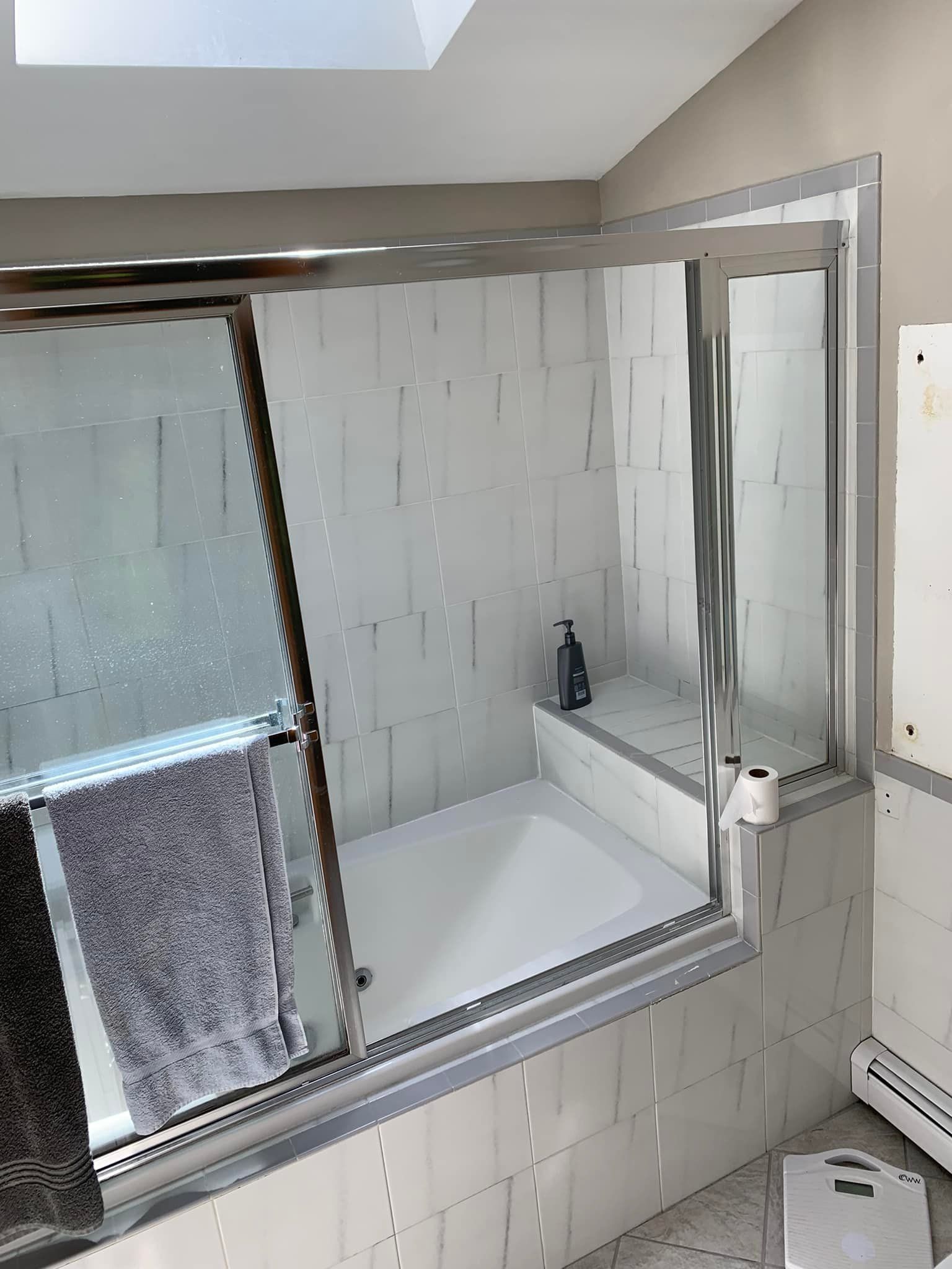 A bathroom with a bathtub and a toilet.