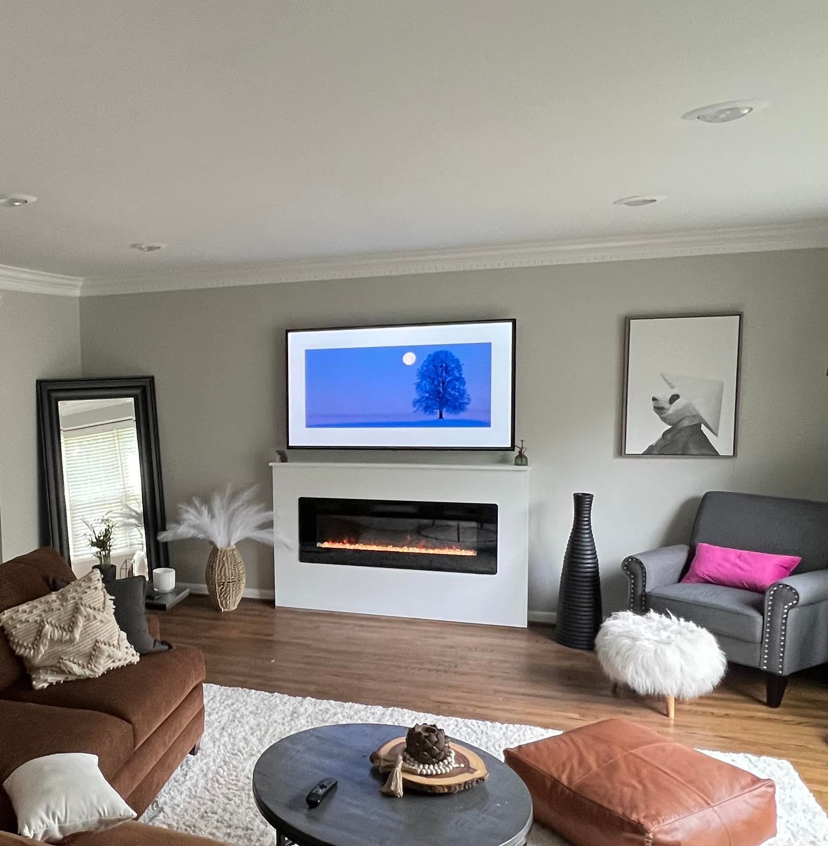 A living room with a fireplace and a flat screen tv