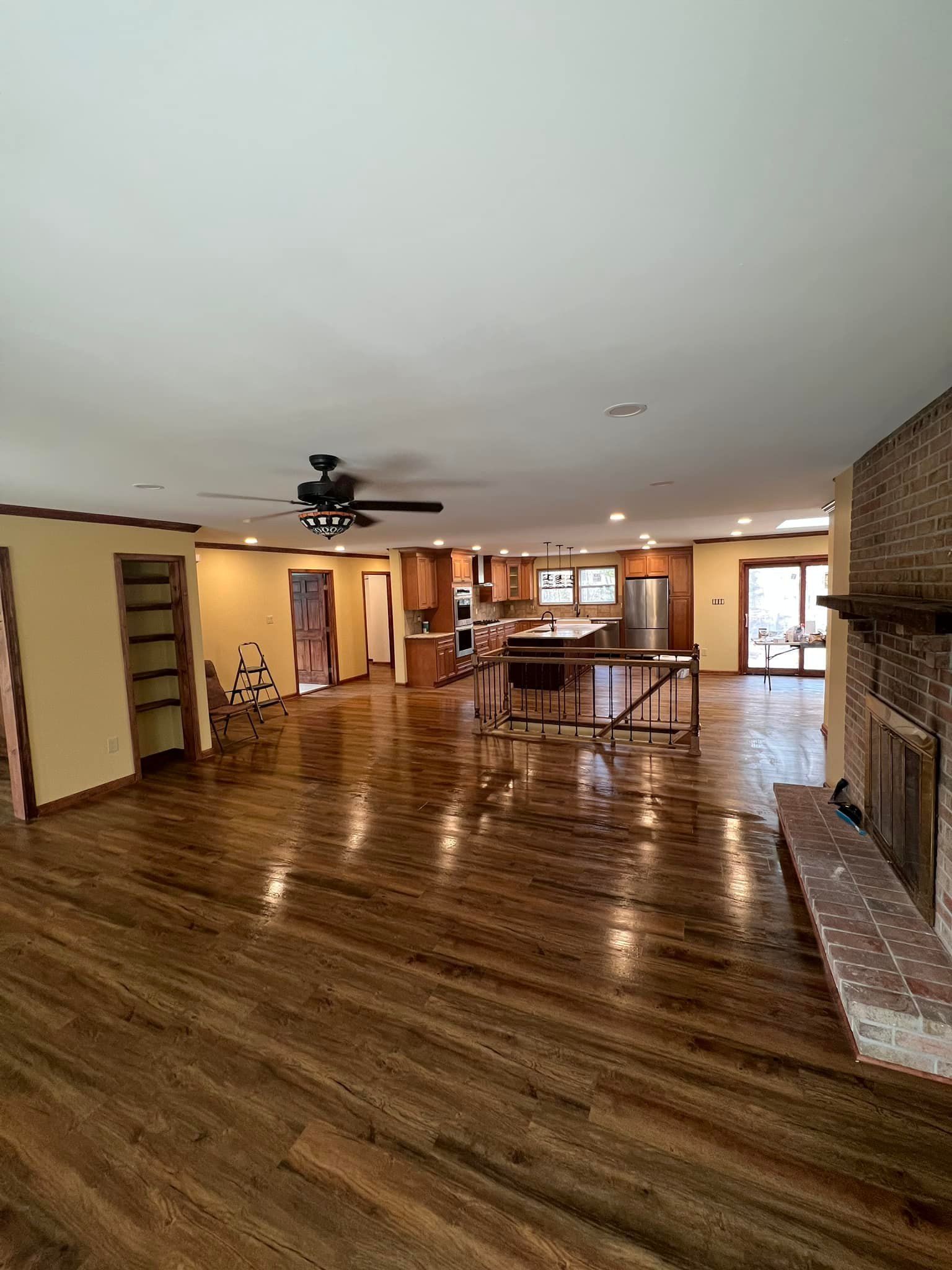A large living room with hardwood floors and a ceiling fan.