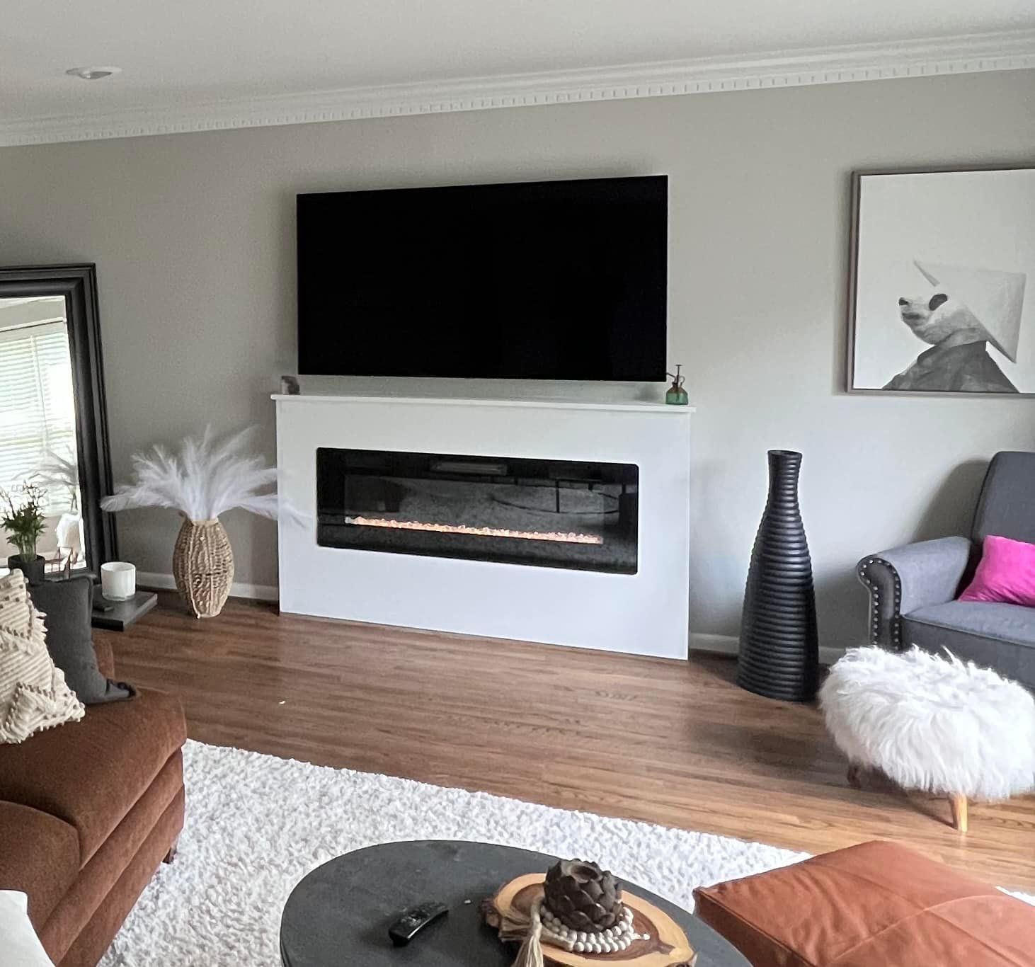 A living room with a fireplace and a flat screen tv