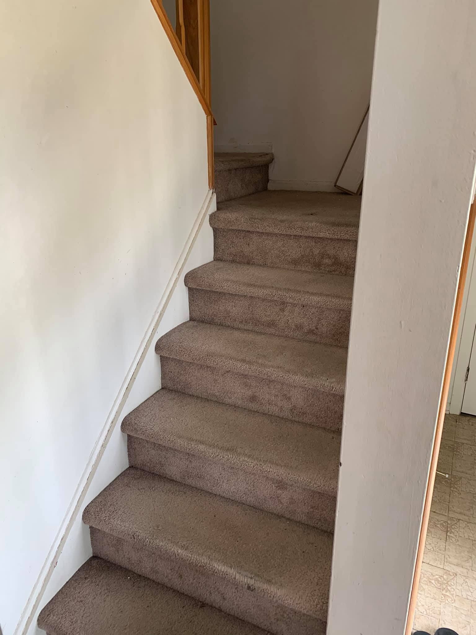 A set of stairs leading up to the second floor of a house.