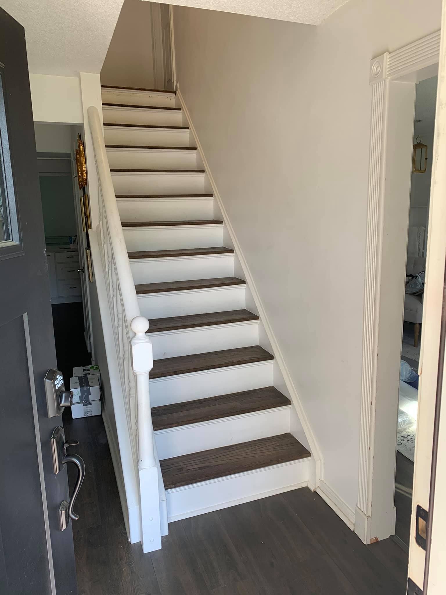 A set of stairs leading up to the second floor of a house.