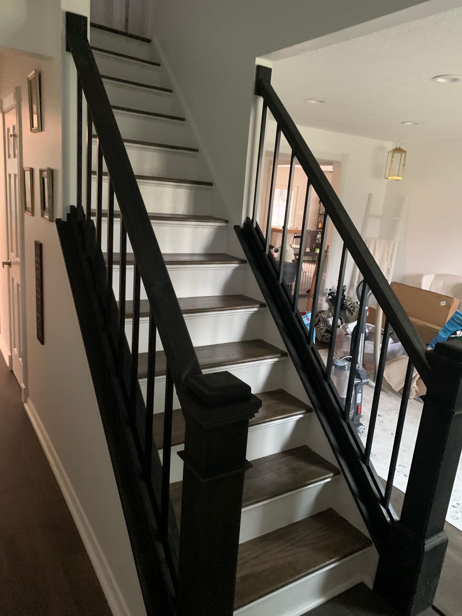A staircase with a black railing and wooden steps in a house