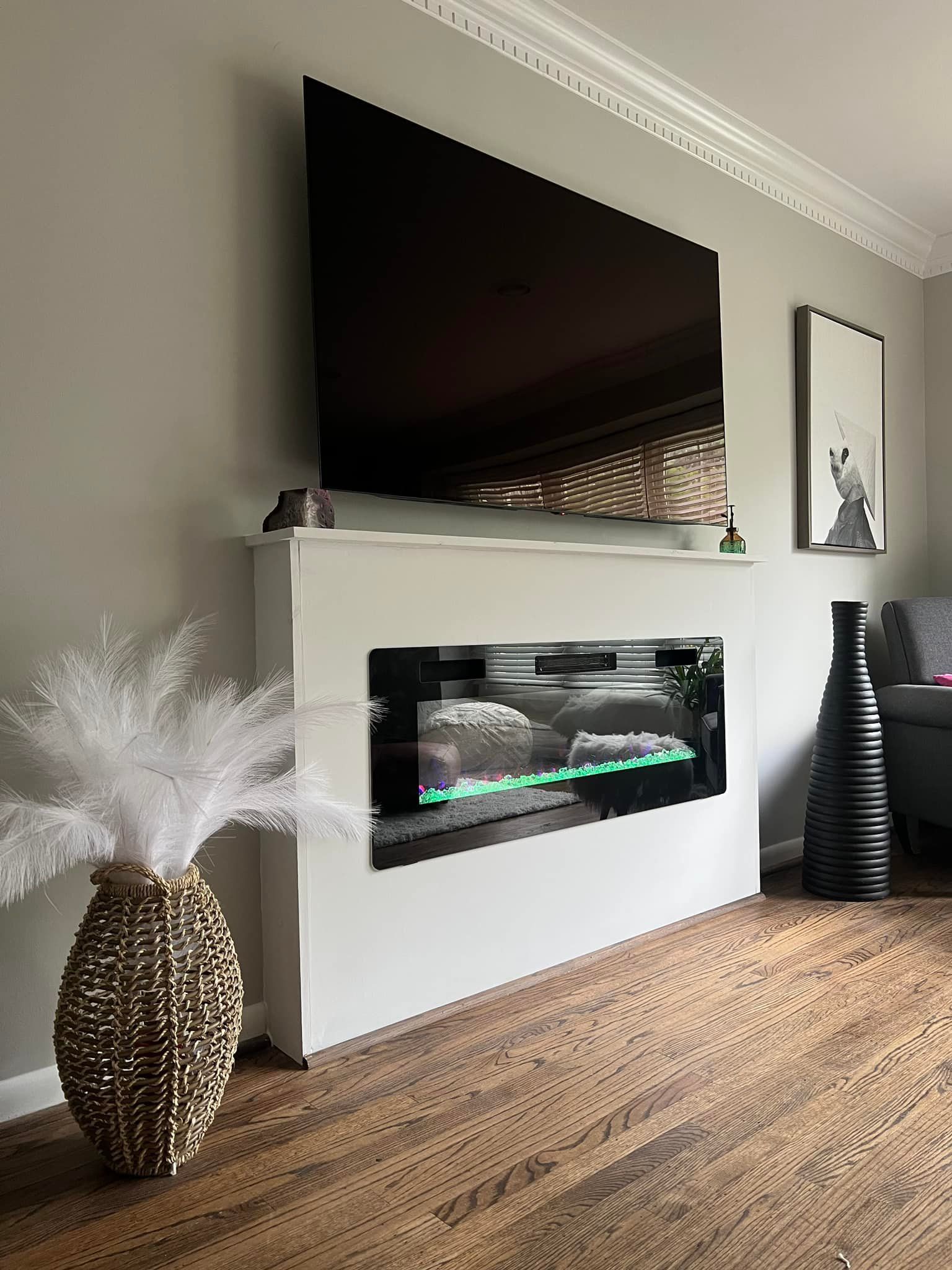 A living room with a fireplace and a flat screen tv.