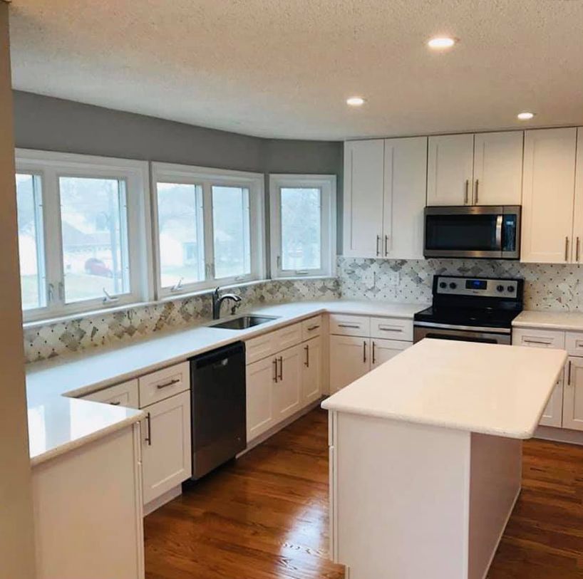 There is a large island in the middle of the kitchen.