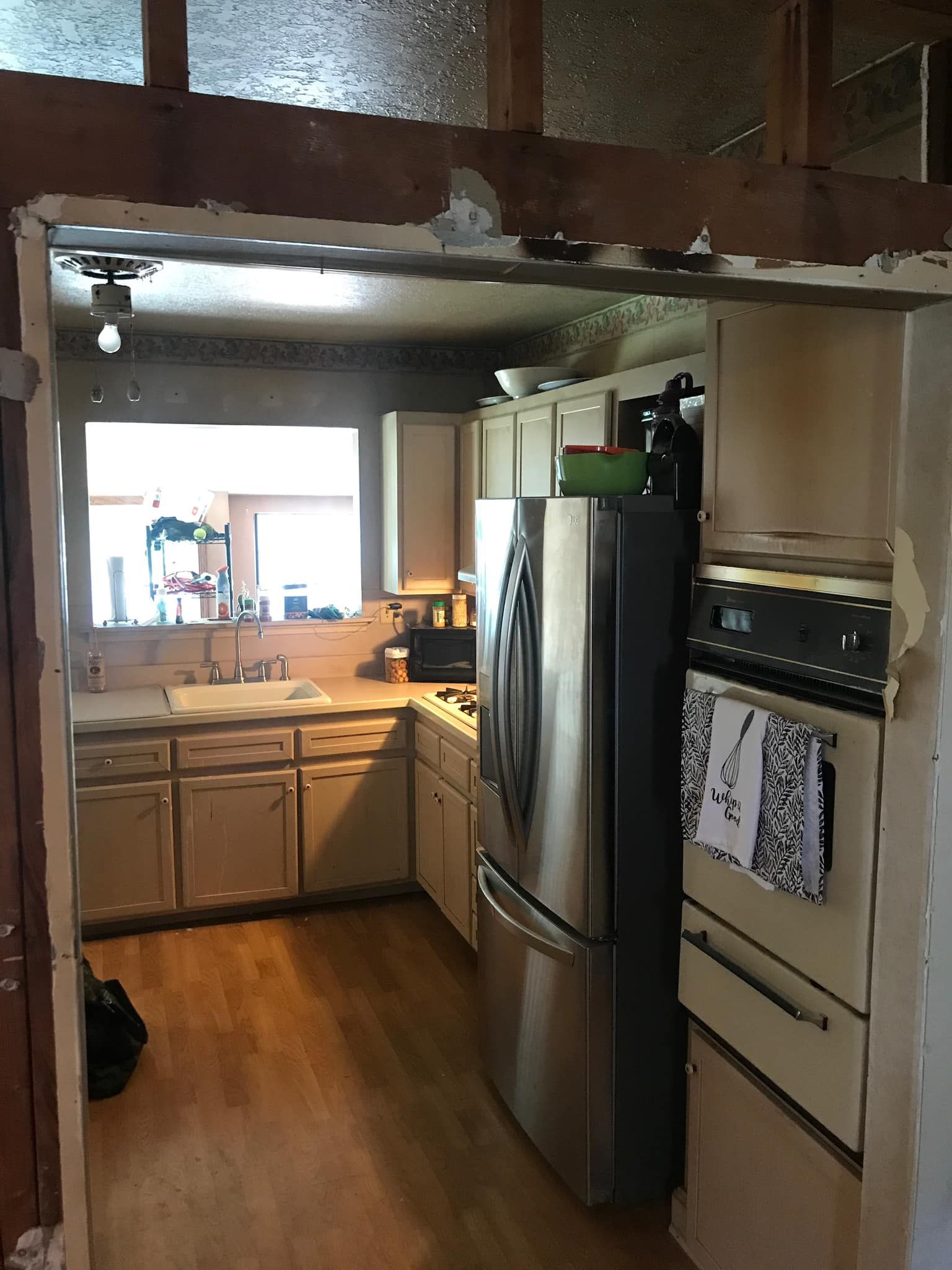 A kitchen with stainless steel appliances and white cabinets