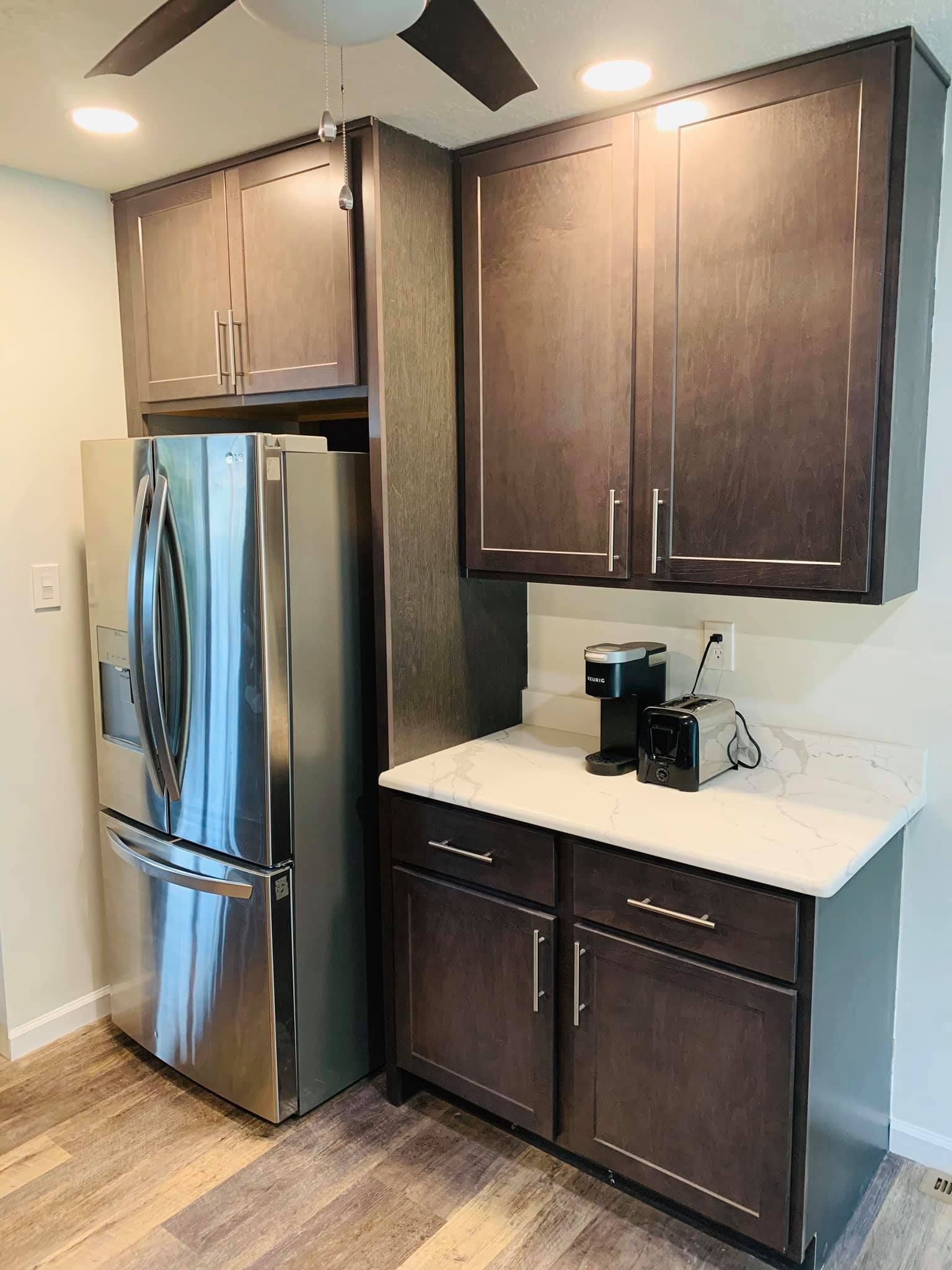 A kitchen with stainless steel appliances and wooden cabinets.