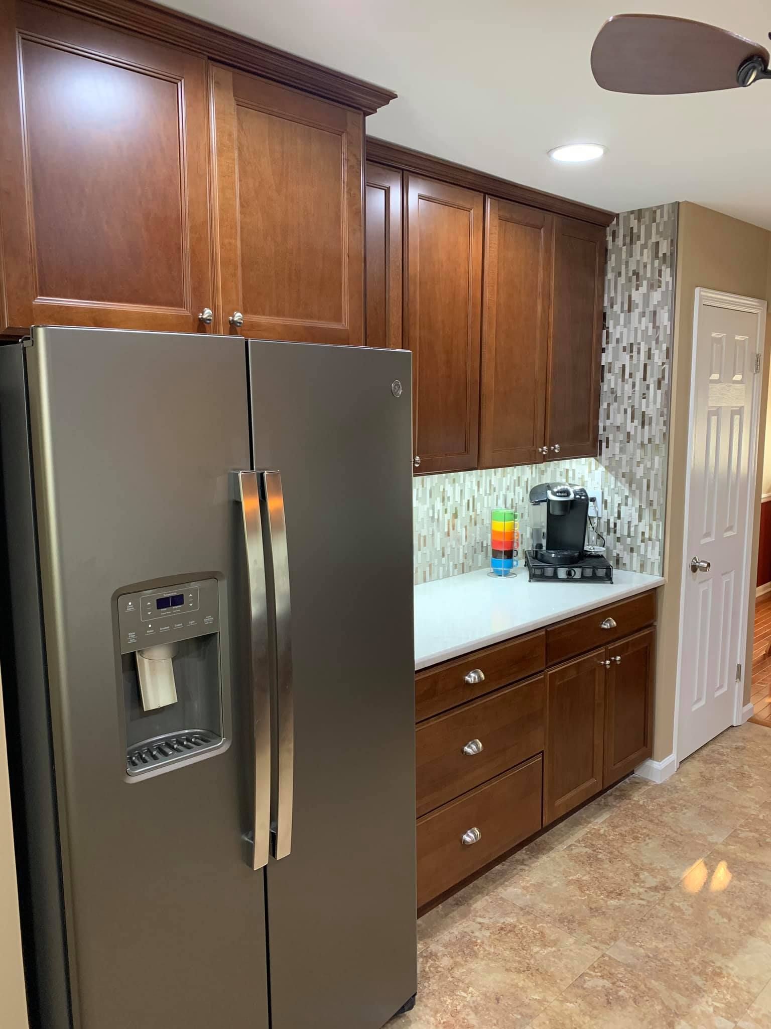 A kitchen with stainless steel appliances and wooden cabinets.
