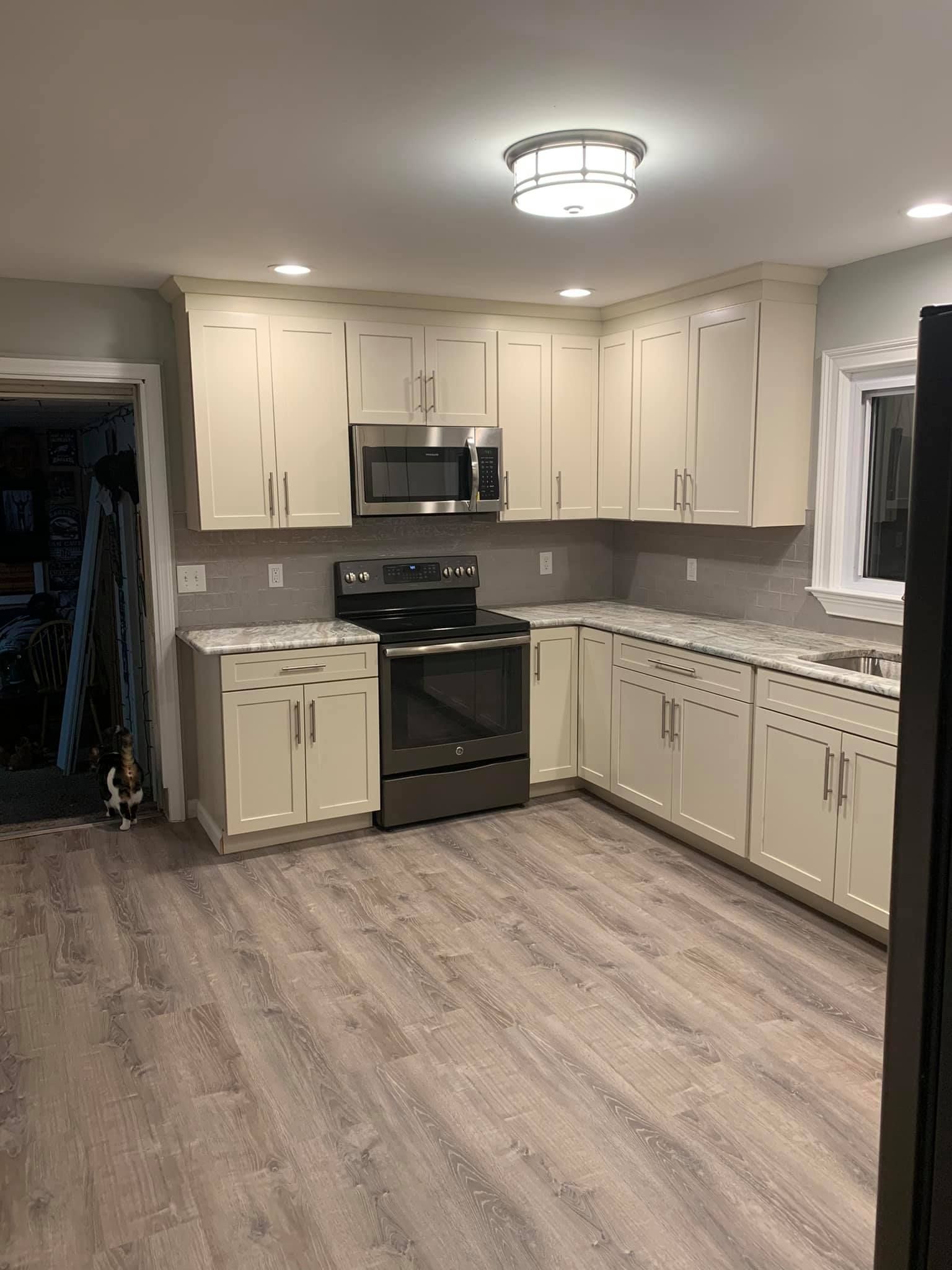A kitchen with white cabinets and stainless steel appliances.