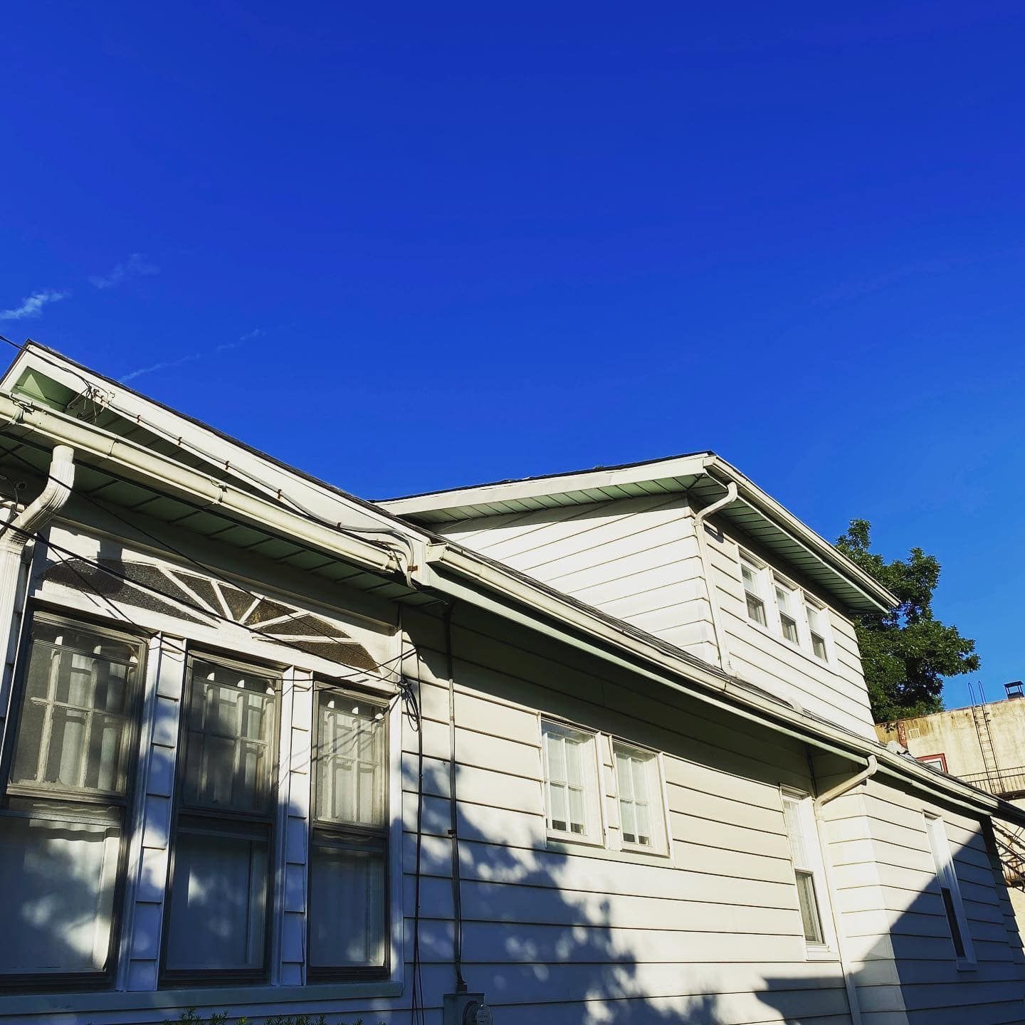 A white house with a blue sky in the background.