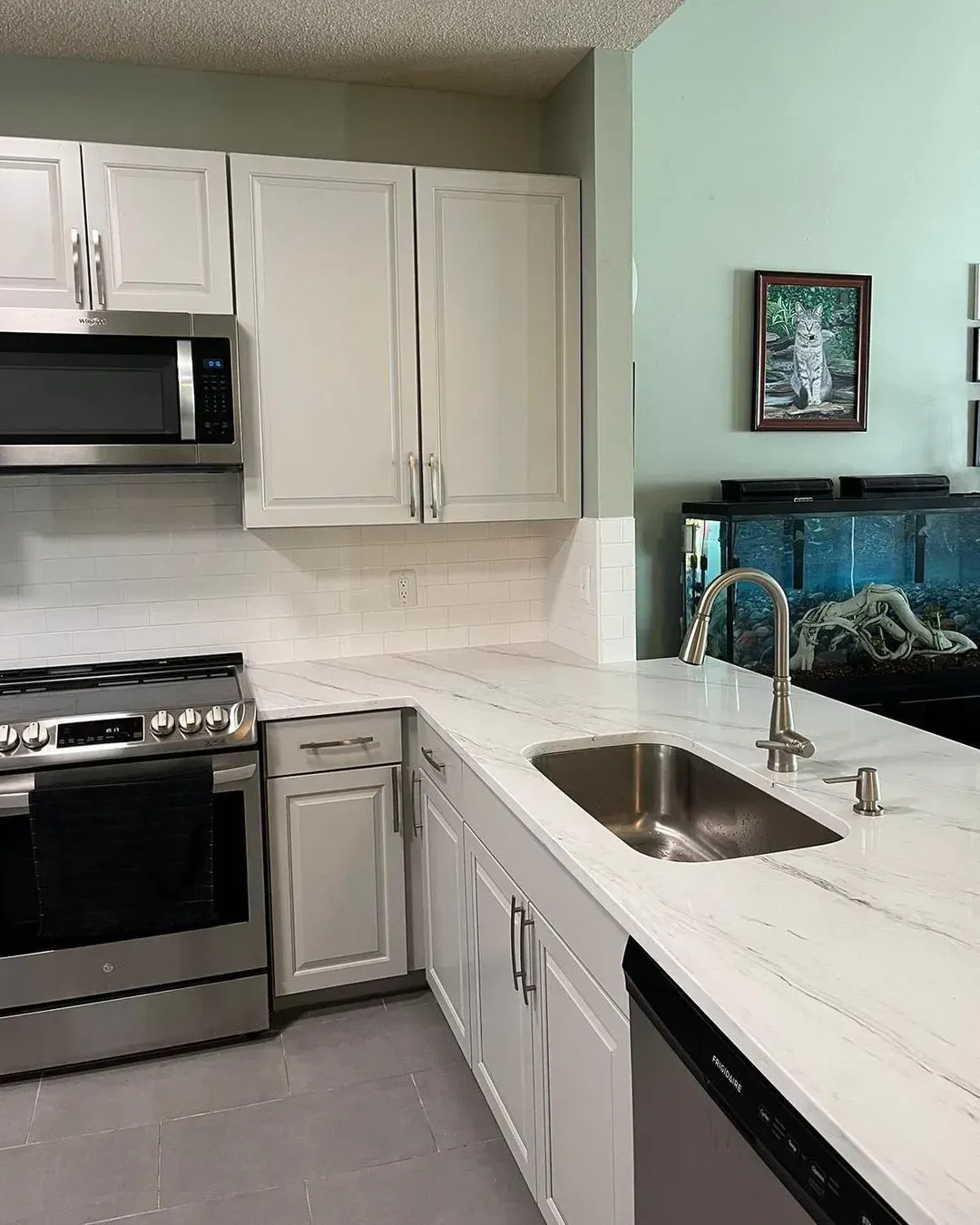 Kitchen with white cabinets, stainless steel appliances, and a light-colored countertop.