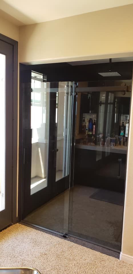 Interior view of glass doors, reflecting a room with items on a counter.
