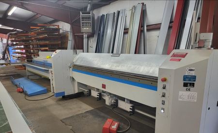 A machine is sitting in a warehouse next to another machine.