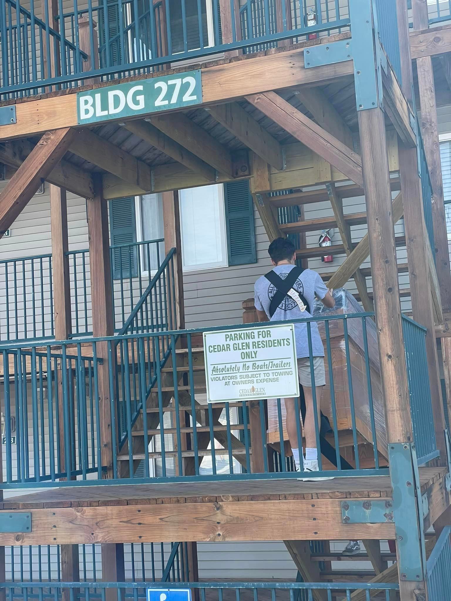 A man is walking up the stairs to bldg 272