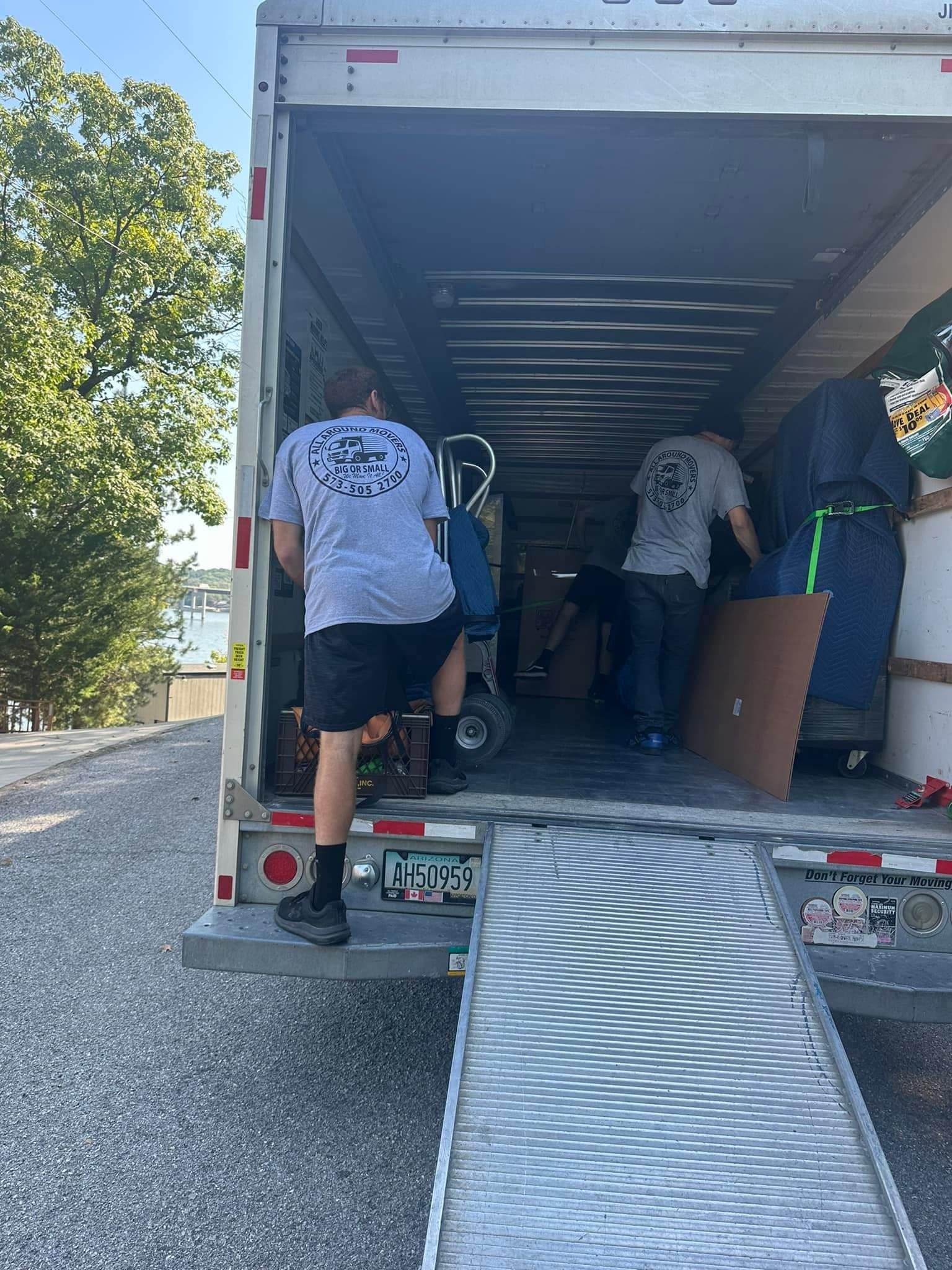 A man is getting out of a moving truck on a ramp.