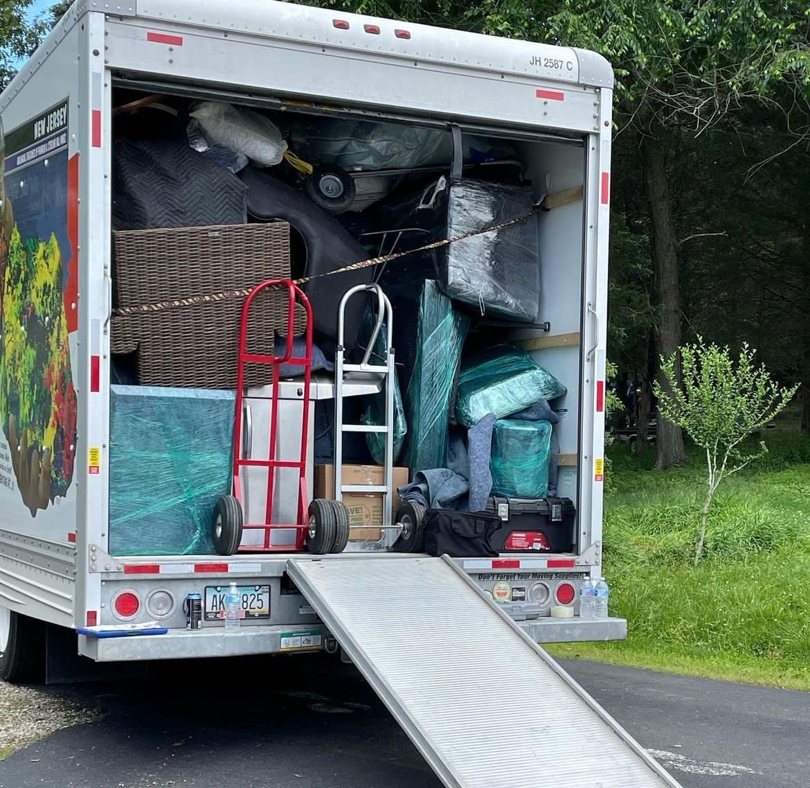 A moving truck is loaded with a lot of stuff