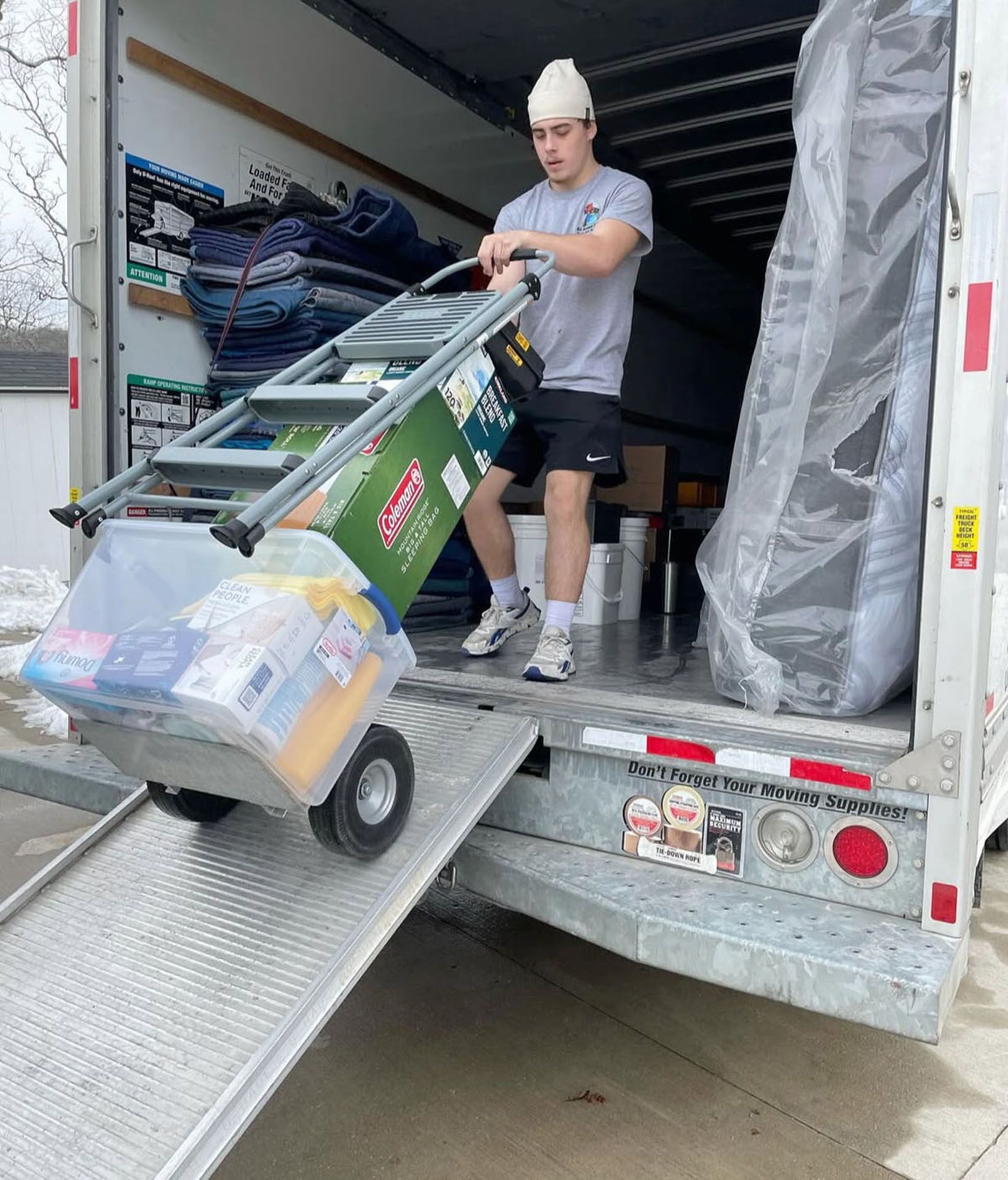 A man is unloading a moving truck