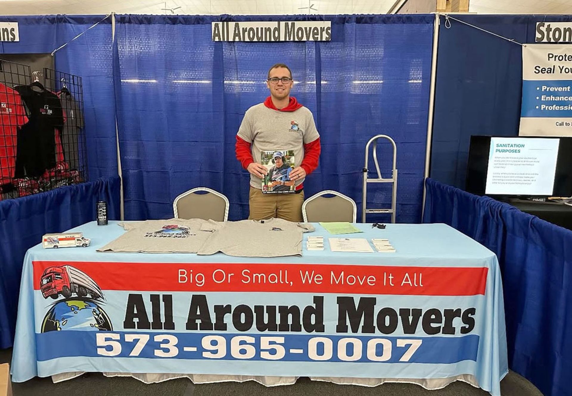 A man standing behind a table