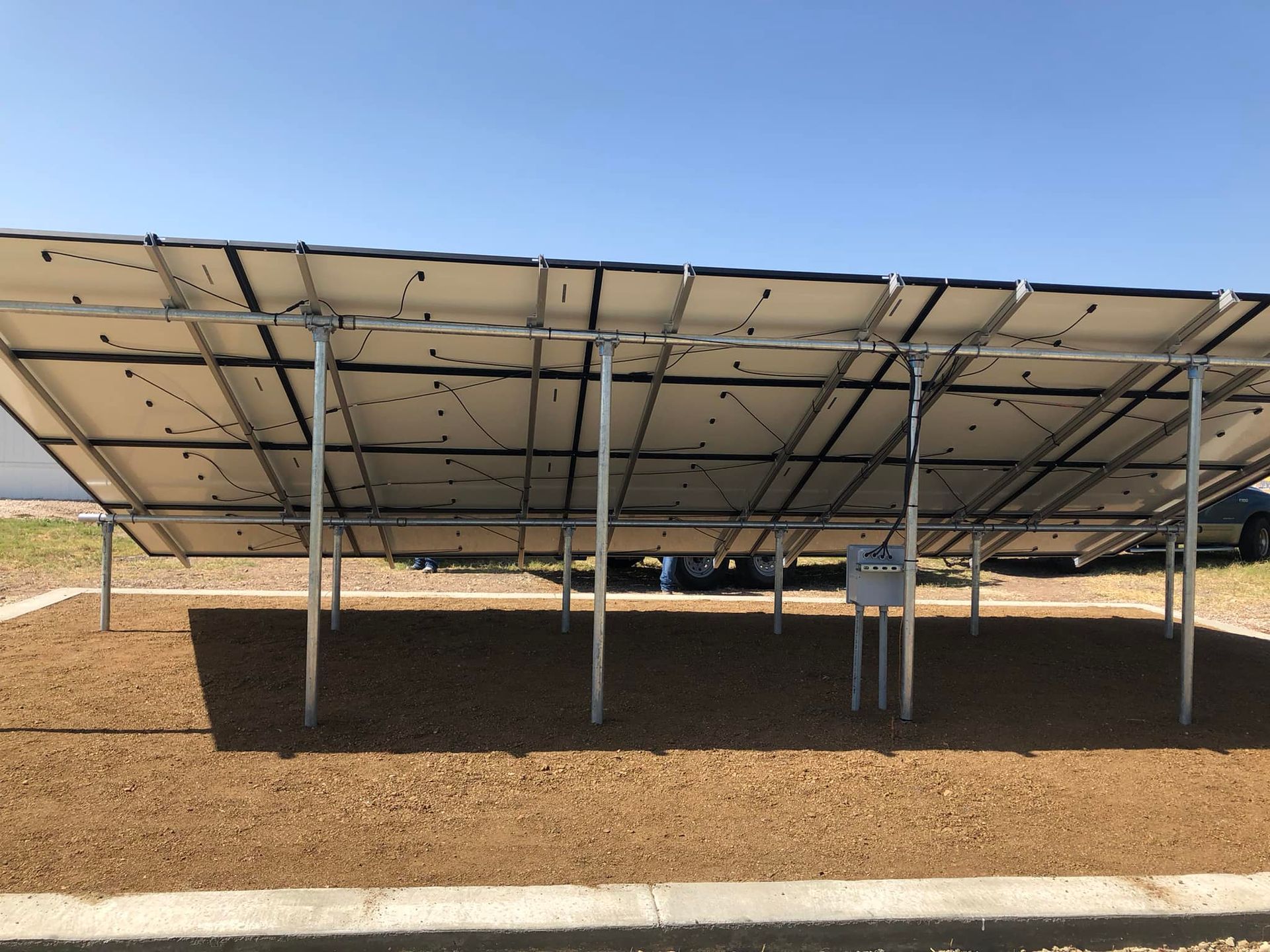 A row of solar panels are lined up in a field