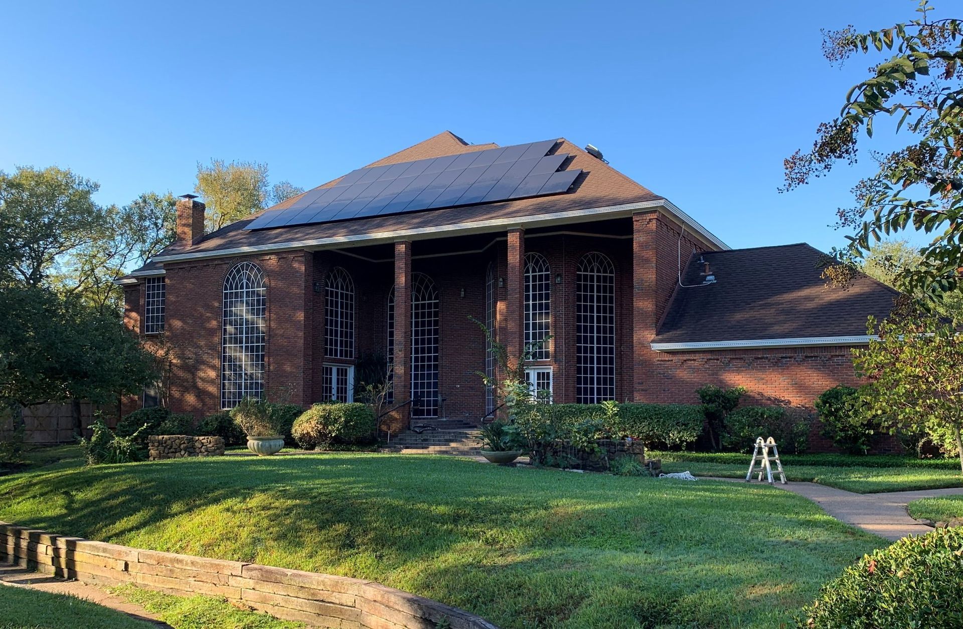 A large brick house with solar panels on the roof