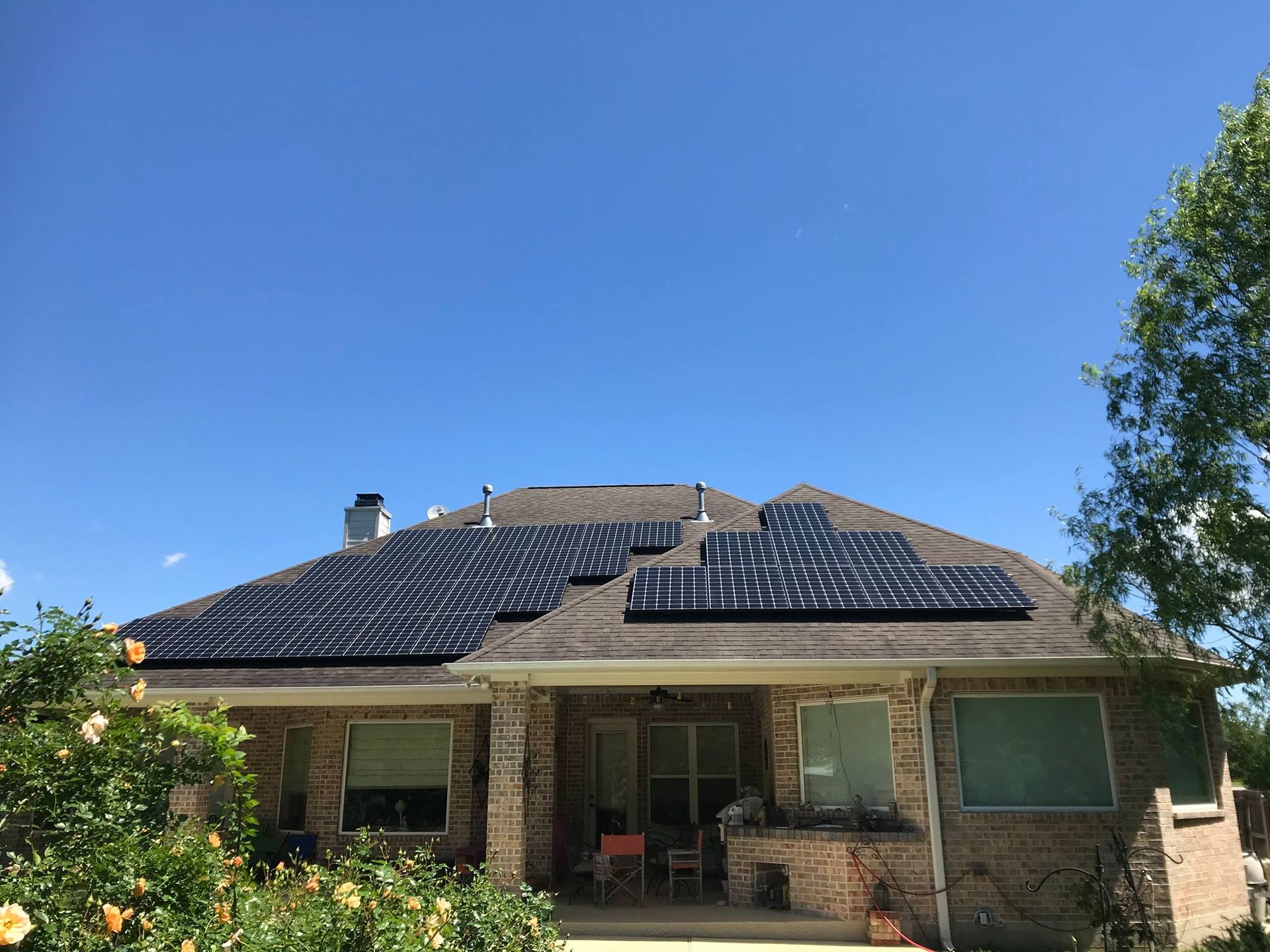A brick house with solar panels on the roof.