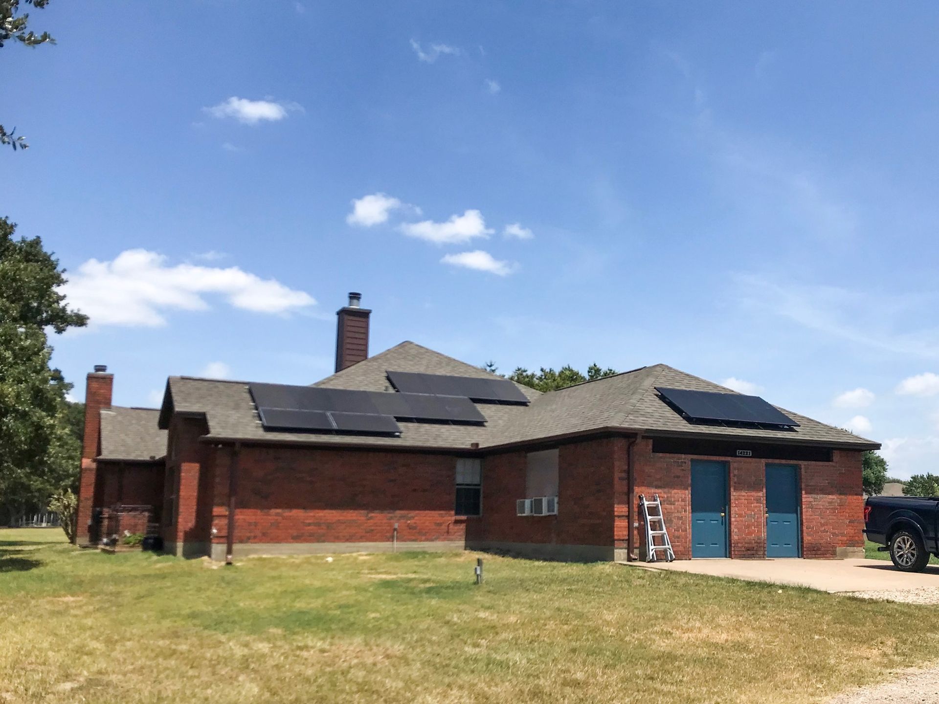 A brick house with solar panels on the roof