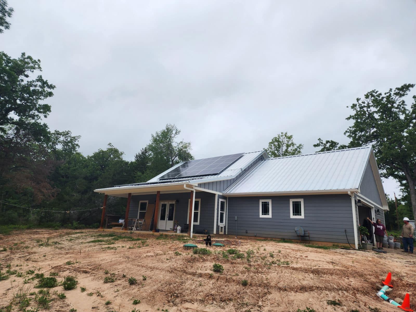 A gray house with solar panels on the roof