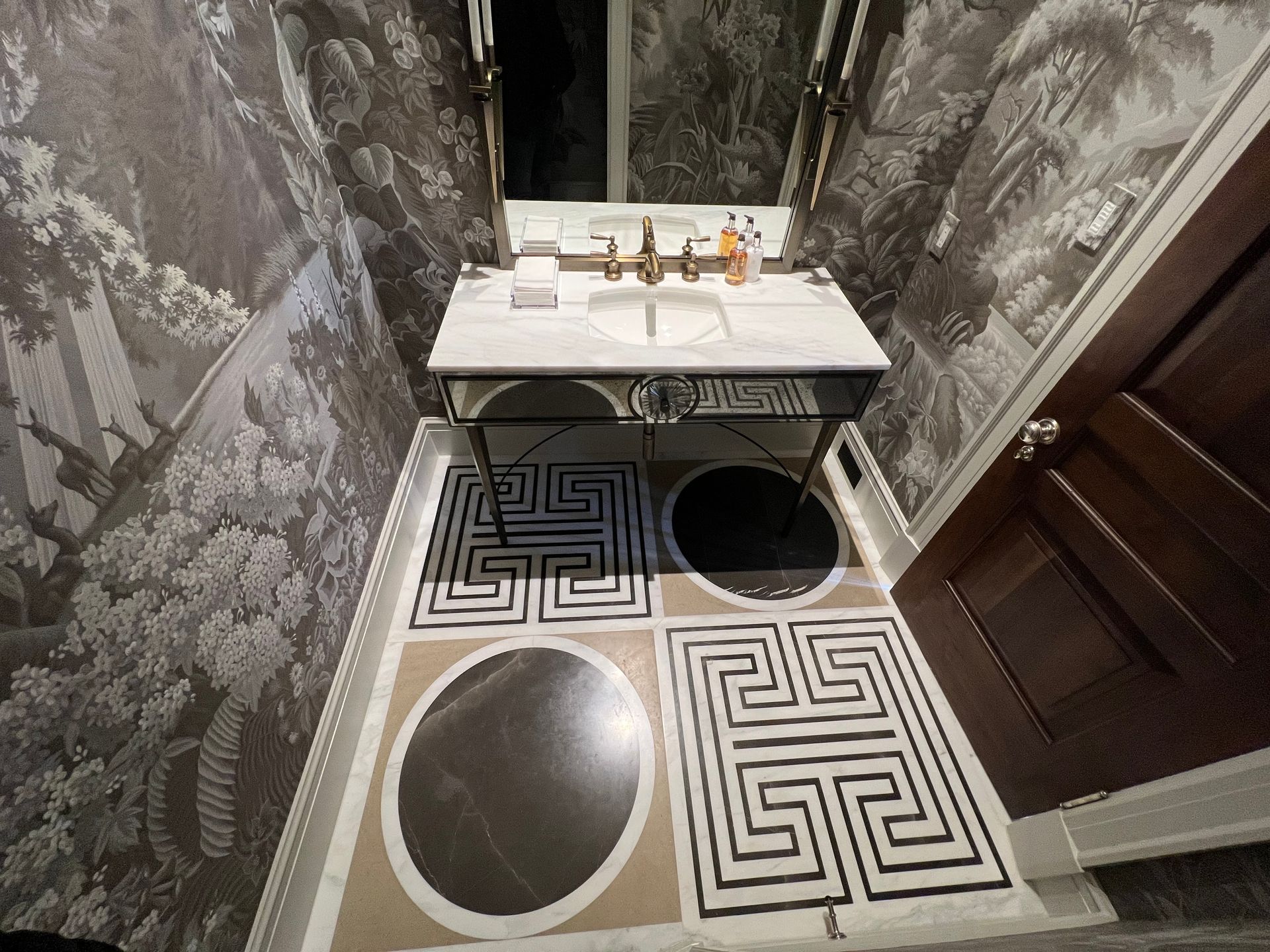 a bathroom with a maze pattern on the floor and a sink