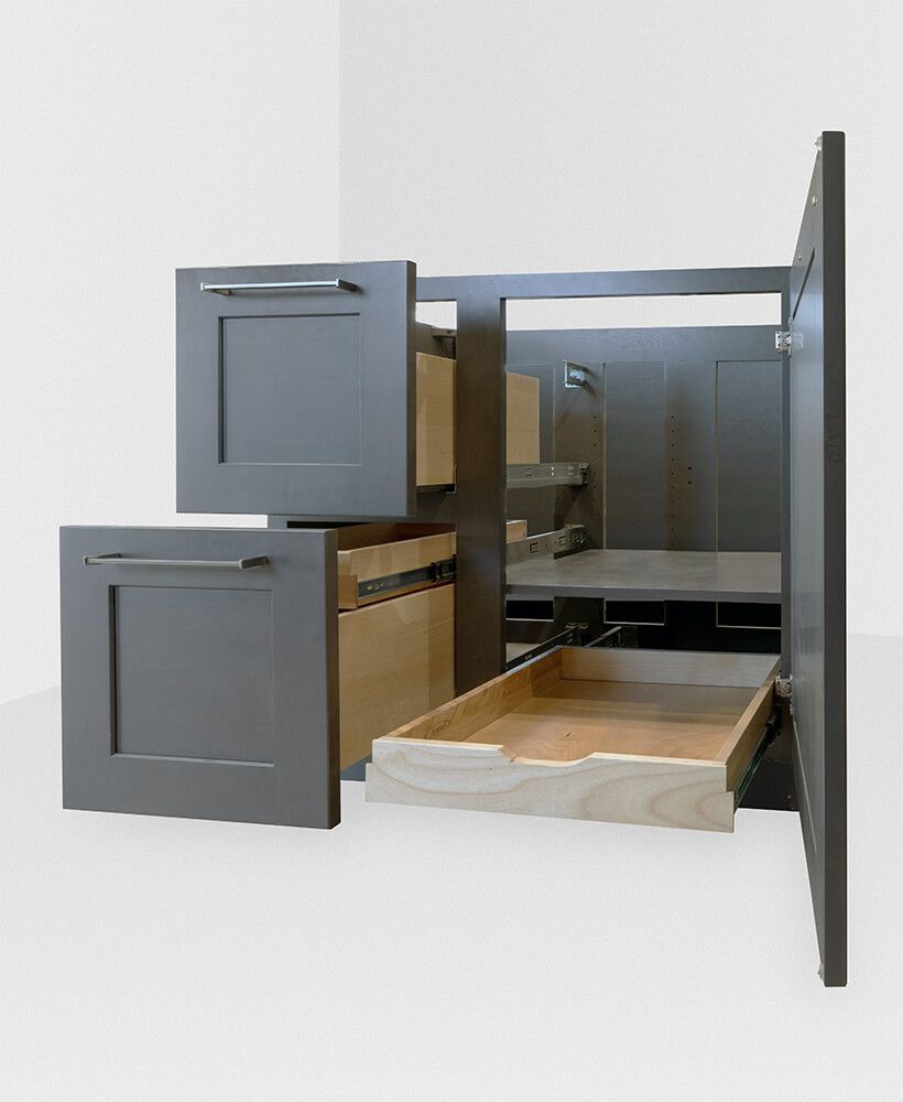 Pull-out cabinet storage with gray drawers and wooden tray extended from a wall cabinet.