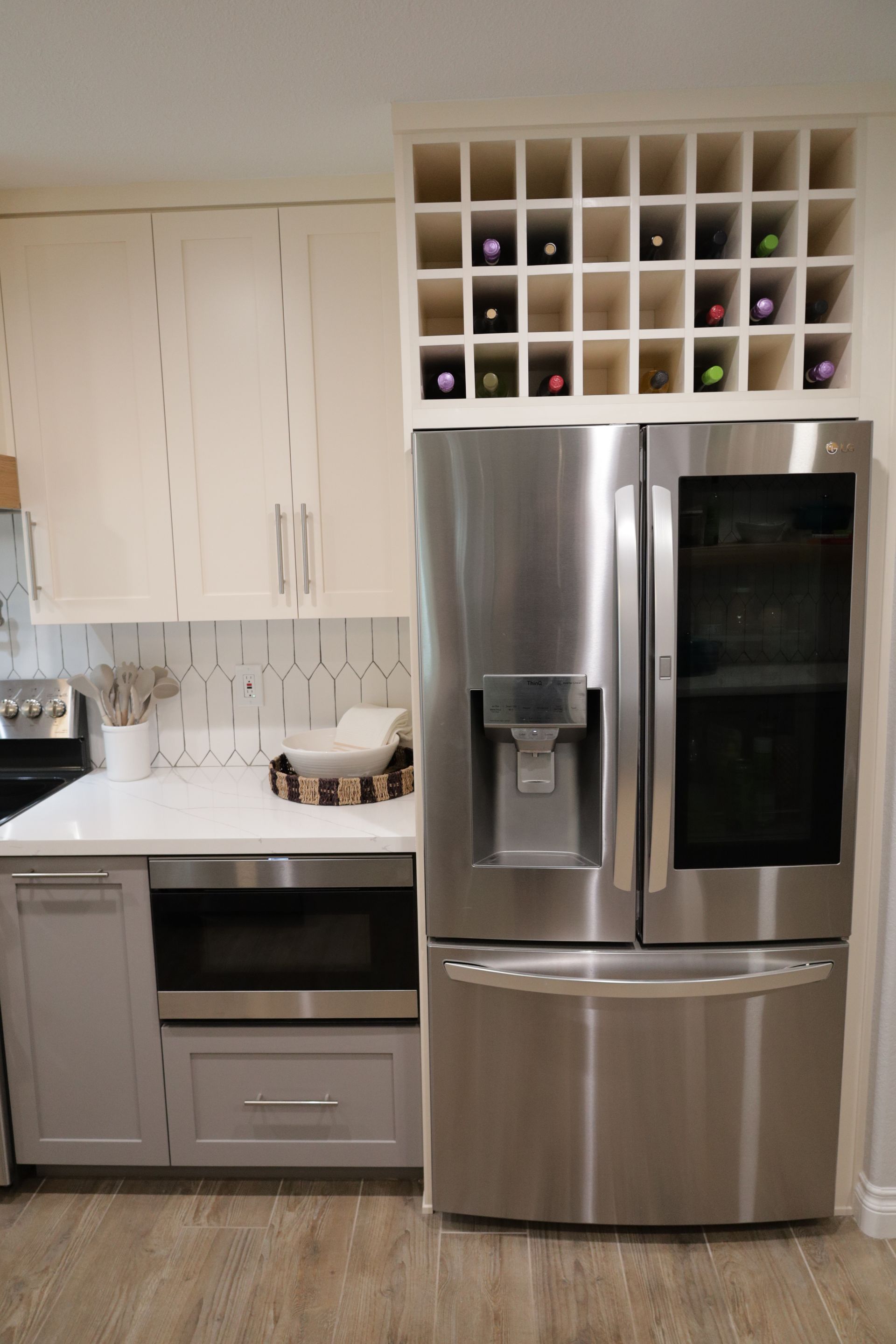 Modern kitchen with stainless steel French door refrigerator and white cabinets