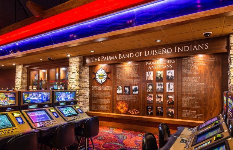 Casino entrance for the Tla’amin Band of Llusu? Indians, with slot machines and warm wood-paneled walls