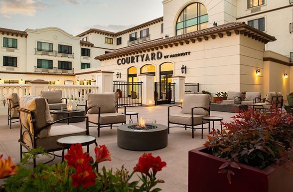 Courtyard hotel courtyard with outdoor seating and fire pit at dusk