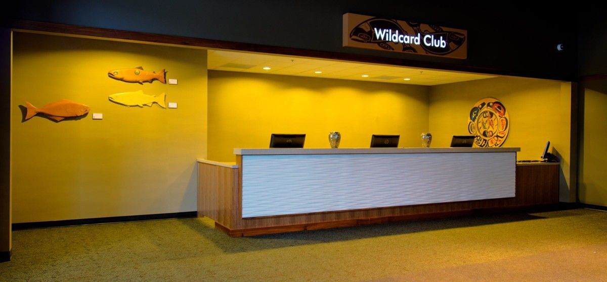 Empty hotel reception desk with a “Wicker Oak” sign and warm yellow wall decor