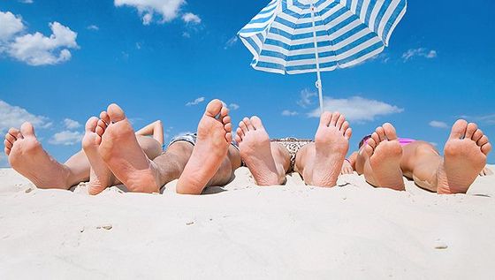 Adults on beach showing their feet