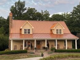 a large house with a copper roof and a porch .