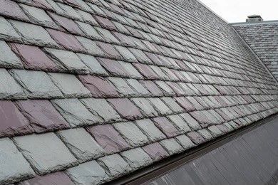 a close up of a roof with slate tiles on it .